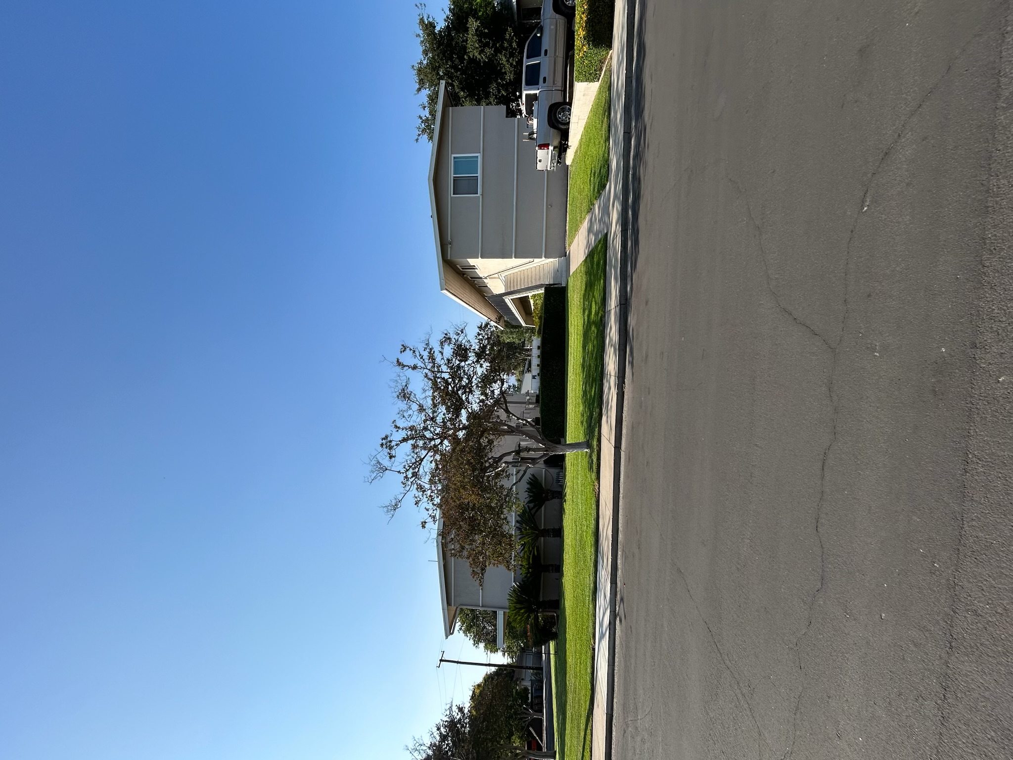 A house with a grey roof and a green lawn.